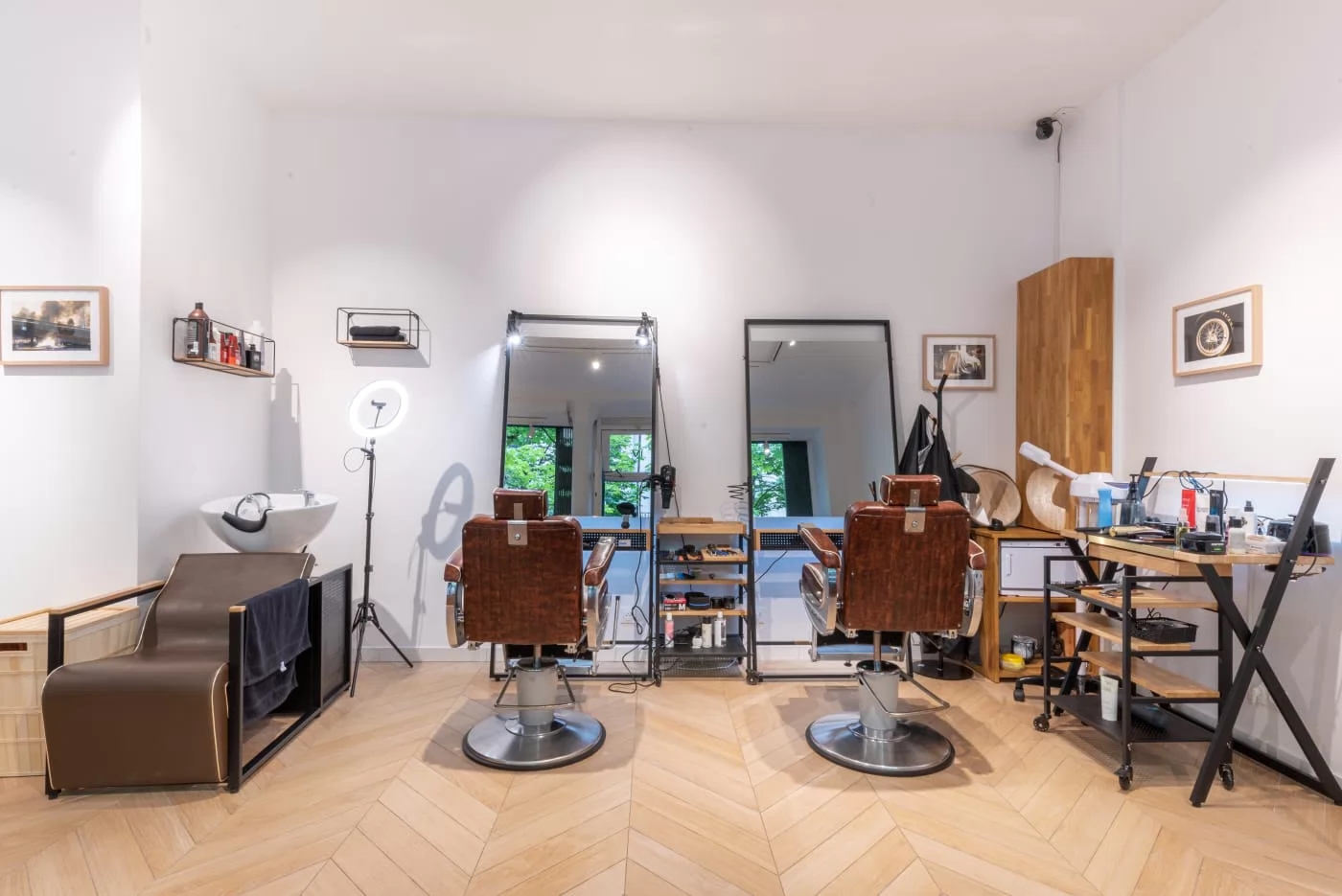 Vue complète des fauteuils de barbier et des miroirs du salon AK Hair